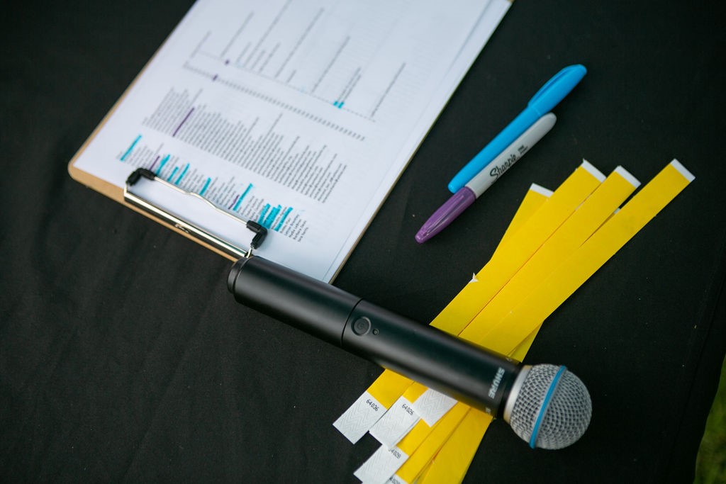 a wireless microphone resting on a table at a Key Signature Entertainment Event. When hiring a live wedding band, consider requesting an additional microphone if you will be delivering the announcements